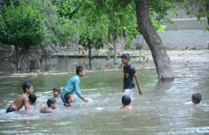 Children find joy in a temporary pond created by rainwater in Malik Pur Park, a week after the downpour,Despite the increasing risk of dengue in the city, it is very important to take notice of the concerned department.