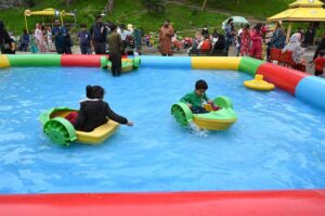 GALIYAT: Aug 19 - Tourist children enjoy a swing at Nathia Gali Park, adding a touch of joy to the scenic beauty.