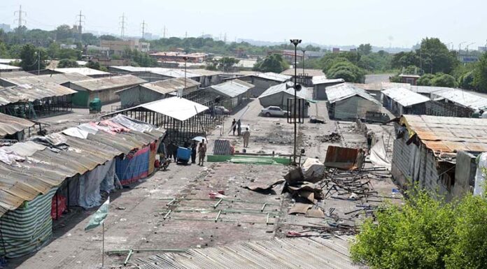 A view of the workers busy rebuilding the stalls at the Peshawar Mor Weekly Bazaar, which was damaged due to a fire