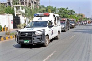 Security officials holding a flag march to develop a sense of protection among the masses and maintain law and order during the Chehlum procession of Hazrat Imam Hussain (R.A).