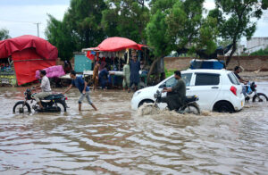 A flooded road in Latifabad Unit 02 after heavy rainfall leaves streets submerged
