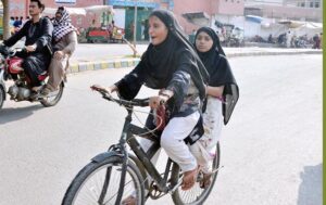 A girl on the way while riding bicycle on the road.