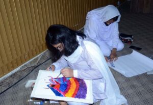 An art student participates in a painting competition that combines art and calligraphy, organized by the Punjab Arts Council Faisalabad for International Youth Day.