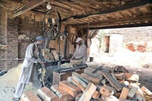 Labourers busy in cutting wood at their workplace, Old Civil Line.