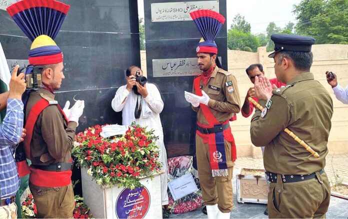 District Police Officer Abdullah Ahmad offering fateha at Yadar-e-Shuda in front of DPO office on the eve of Youm-e-Shuda Police