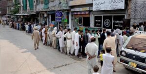 Deserving people receive free food from volunteers at Banni Chowk
