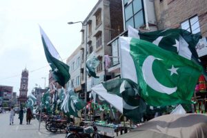 Shopkeepers displaying a huge national flag outside their shops to attract the customers as the nation starts preparations to celebrate Independence Day in befitting manners at Aminpur Bazaar.