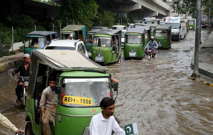 Vehicles passing through stagnant rain water accumulated at Suray Pull Chowk after heavy rain in the city Vehicles passing through stagnant rain water accumulated at Suray Pull Chowk after heavy rain in the city