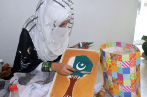 Student create a vibrant national flag at Alhamra Arts Council's summer camp for Independence Day.