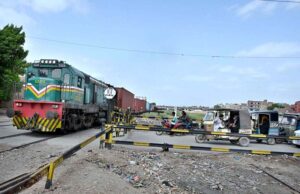 A view of vehicles waiting as goods train crossing at Makki Shah Railway Crossing.