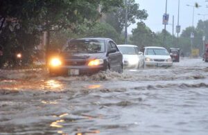 Vehicles passing through rainwater accumulated on the Kalma Chowk Road during heavy monsoon rain in the city.
