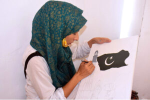 Student create a vibrant national flag at Alhamra Arts Council's summer camp for Independence Day.