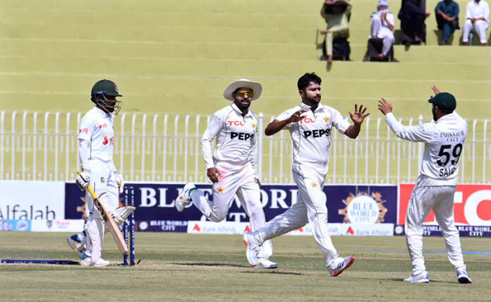 Pakistan players celebrate after dismissing Bangladesh's Mominul Haque during the third day of the 1st Test match at Pindi Cricket Stadium in the twin cities