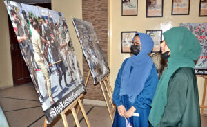 Students are viewing pictures during an exhibition to mark the Youm-e-Istehsal Kashmir (Exploitation Day) organized by the Arts Council.