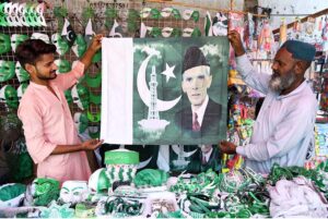 Vendor displaying national flag caps and other stuff to attract the customers in connection with upcoming Independence Day celebrations