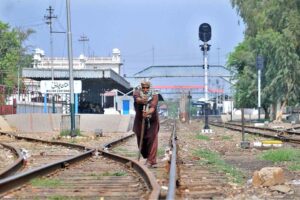 Pakistan Railway maintenance worker inspect and repair railway tracks ,ensuring safety and preventing potential mishaps near the railway station