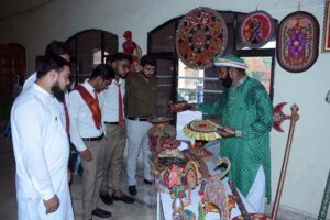 Visitors are viewing at displayed items during a Craft Exhibition arranged at Faisalabad Arts Council in connection with 77th Independence Day celebrations