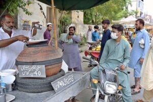 A vendor selling traditional summer drink ‘lassi’ on his cart in front of Company Bagh.
