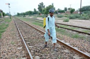 A worker spraying herbicides on his Railway track to eliminate weeds.