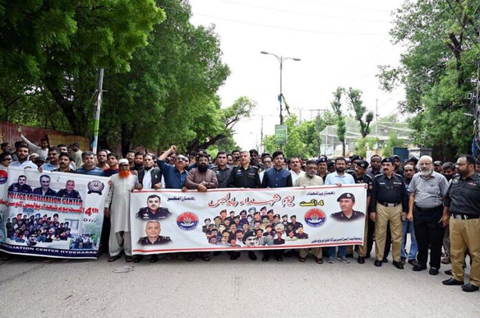 SSP Dr. Farukh Ali along with other police officials and business community participating in a walk to mark Youm-e-Shuhada Police at Court Road