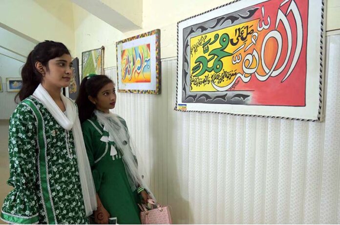 Young Girls are visiting calligraphic exhibition at Sargodha Arts Council during celebration of Independence Day