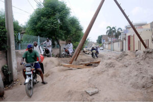 Workers painting the wall of flyover at Kalma Chowk