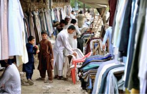 Vendor displaying old clothes to attract the customers at Ferdos area in Provincial Capital.