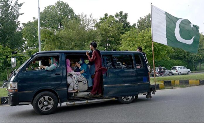 A big-sized national flag placed on a van to mark the Independence Day celebrations