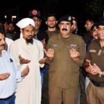 SP Ghulam Abbas is lighting a candle in the memory of martyred police officers at the district police office on Police Martyrs' Day