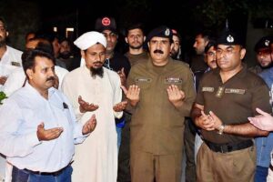SP Ghulam Abbas is lighting a candle in the memory of martyred police officers at the district police office on Police Martyrs' Day