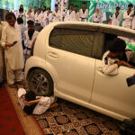 Karate players demonstrating tricks from car during Independence Day at circuit house
