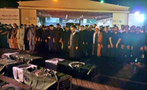People carrying the coffin of martyrs of bus accident in Iran after offering funeral prayers at Zulfiqar Bagh.