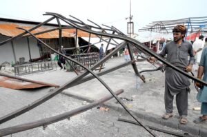 CDA workers work on restoring stalls after the fire at H-9 weekly bazaar in the Federal Capital