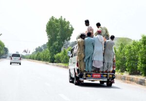Passengers traveling on the rooftop of a van at Larkana- Sukkur Road may cause any mishap and needs the attention of concerned authorities.