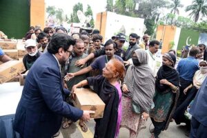 Governor Sindh Kamran Khan Tessori distributing ration bags to the beneficiaries at the Governor House