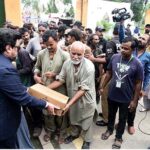 Governor Sindh Kamran Khan Tessori distributing ration bags to the beneficiaries at the Governor House