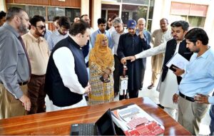 Additional Chief Secretary South Punjab Fawad Hashim Rabbani inspecting the electrical white stick for the blind made by the students at the Muhammad Nawaz Sharif University of Engineering & Technology. Vice Chancellor Professor Dr. Kamran Khan and students are also present.