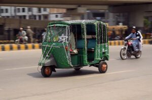 Motorists display huge national flag on the eve of Independence Day.
