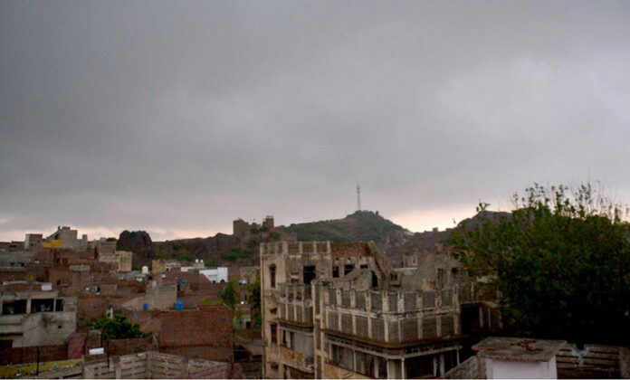 Thick clouds hover over the city, signaling an impending downpour