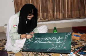 A woman looks at rare tickets at GPO Multan on the occasion of Independence Day.