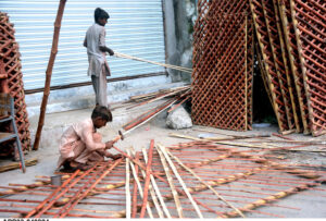 Youngsters busy in preparing bamboo fence at their workplace.
