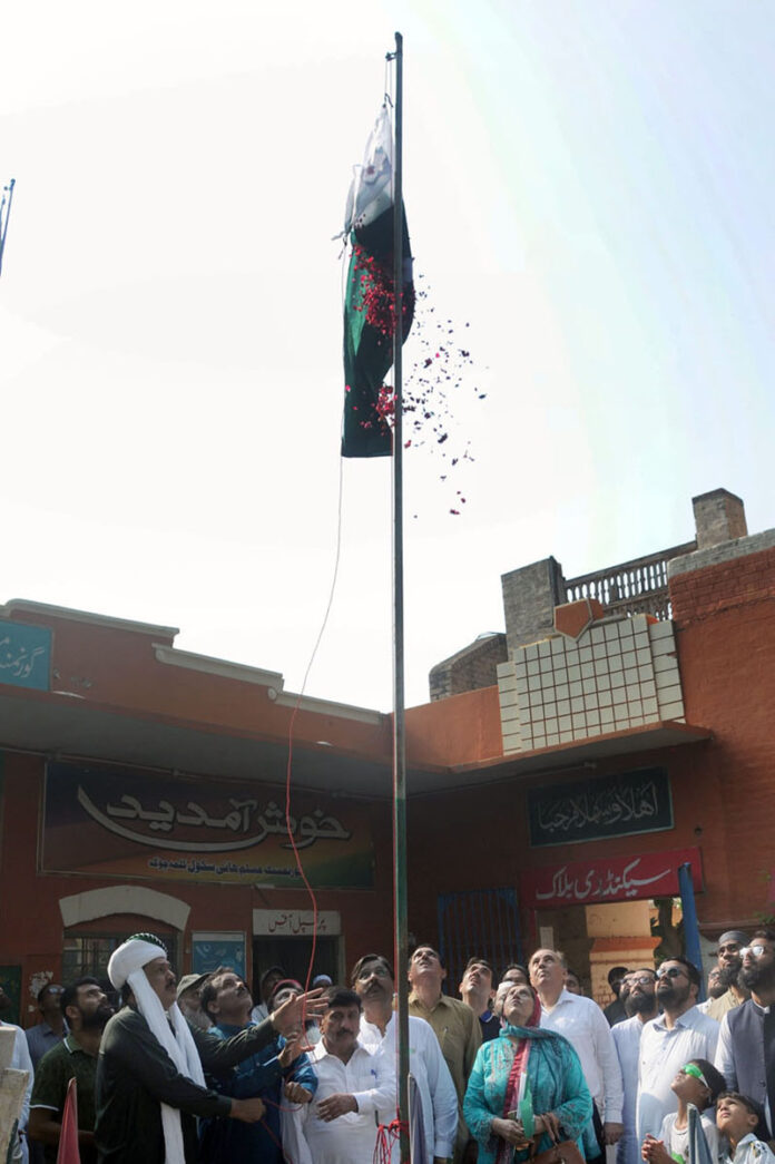 Principal Muslim High School Rana Aslam is hoisting Pakistan’s national flag ceremony on the 77th Independence Day of Pakistan