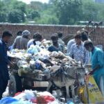 Gypsy people scavenge for valuable items amidst the garbage at Rajawala