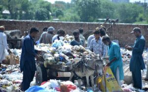 Gypsy people scavenge for valuable items amidst the garbage at Rajawala