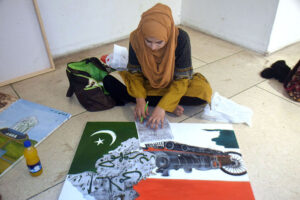 Art student engages in calligraphy along with painting during art classes at the summer camp at Alhamra Arts Council Academy in Provincial Capital.