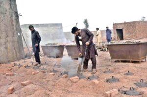 Workers busy in routine work at a brick kiln house.