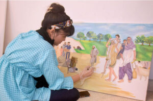 Art student engages in calligraphy along with painting during art classes at the summer camp at Alhamra Arts Council Academy in Provincial Capital.