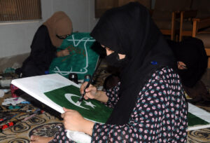 A woman looks at rare tickets at GPO Multan on the occasion of Independence Day.