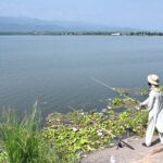 A man fishing at Rawal Lake near Bani Gala