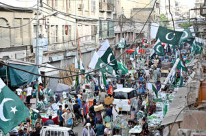 A woman vendor sells bangles and other items at her stall as the nation gears up for Independence Day celebrations.
